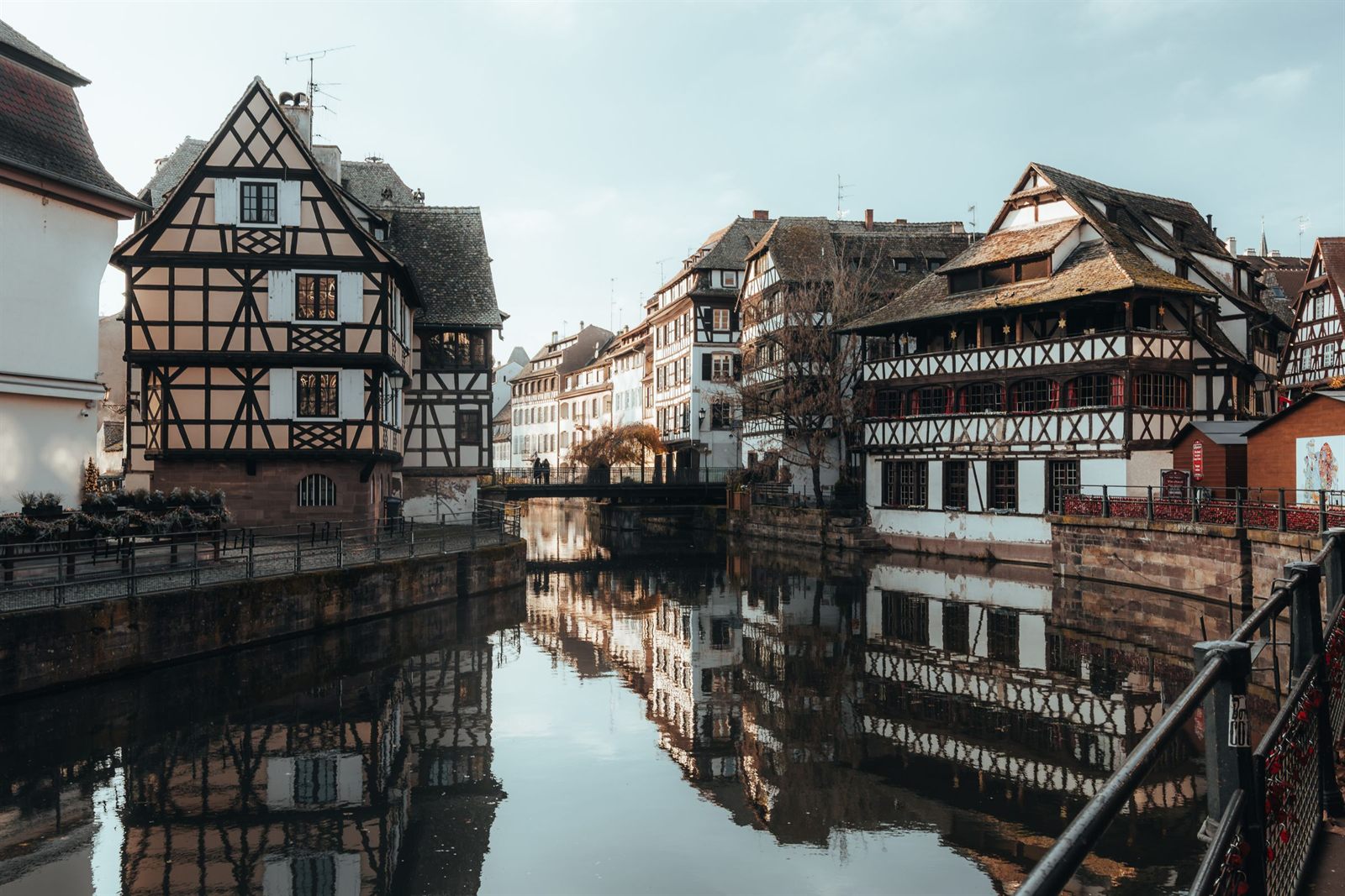 Old timbered houses reflected in still canal water in Strasbourg